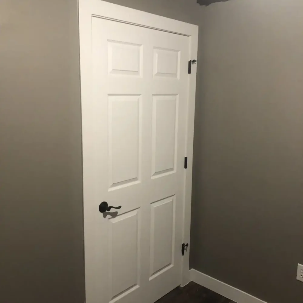 Dark Metal Accents on a Modern White Door